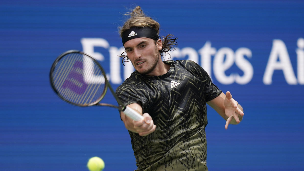 Stefanos Tsitsipas, of Greece, returns a shot to Andy Murray, of Great Britain, during the first round of the US Open tennis championships, Monday, Aug. 30, 2021, in New York. (AP Photo/Seth Wenig)