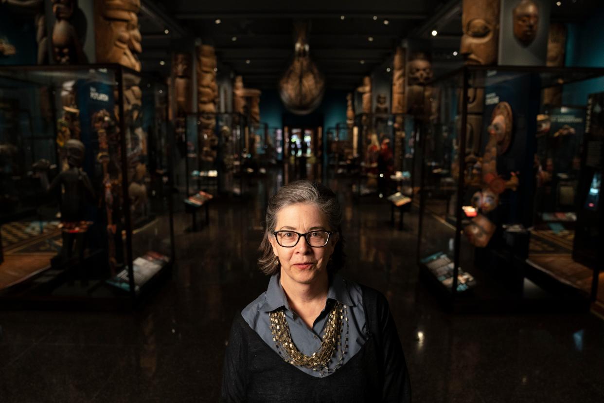 Lauri Halderman, vice president for exhibition at the American Museum of Natural History, stands for a portrait surrounded by artifacts, dioramas, and representations of Native American culture,