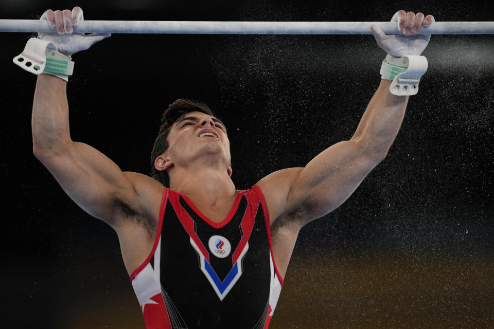 Artur Dalaloyan, of the Russian Olympic Committee, trains on the horizontal bar for the artistic gymnastics at Ariake Gymnastics Centre venue ahead of the 2020 Summer Olympics, Wednesday, July 21, 2021, in Tokyo. (AP Photo/Natacha Pisarenko)