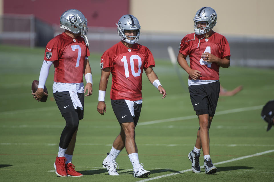 Las Vegas Raiders quarterbacks Brian Hoyer (7), Jimmy Garoppolo (10), and Aidan O'Connell (4) talk during practice at the NFL football team’s training camp, Saturday, July 29, 2023, in Henderson, Nev. (AP Photo/Sam Morris)