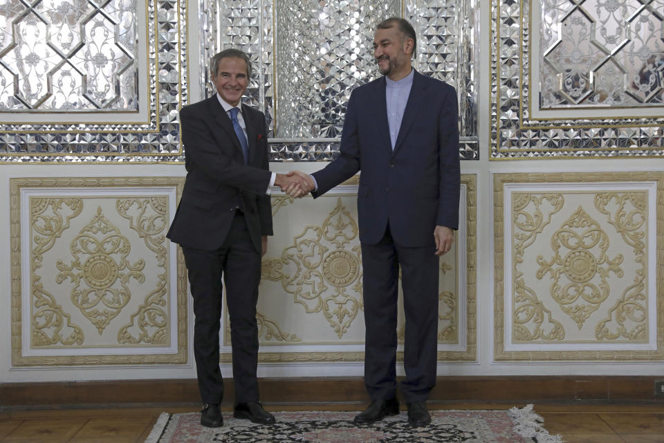 Head of the International Atomic Energy Agency, IAEA, Rafael Mariano Grossi, left, and Iranian Foreign Minister Hossein Amirabdollahian shake hands for the media prior to their meeting, in Tehran, Iran, Tuesday, Nov. 23, 2021. Grossi met Tuesday with Iranian officials to press for greater access in the Islamic Republic ahead of diplomatic talks restarting over Tehran's tattered nuclear deal with world powers. (AP Photo/Vahid Salemi)