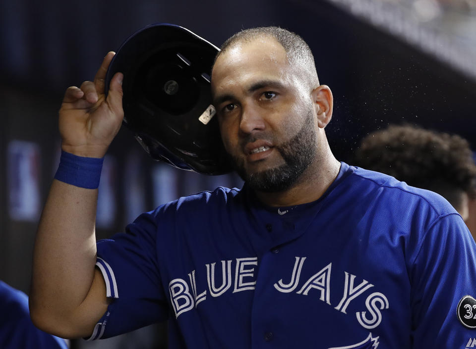 Toronto Blue Jays Kendrys Morales removes his helmet in the dugout after scoring during the third inning of a baseball game against the Miami Marlins, Sunday, Sept. 2, 2018, in Miami. (AP Photo/Brynn Anderson)