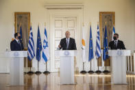 Greek Foreign Minister Nikos Dendias, centre, speaks during a join news conference next to his Israel's counterpart Gabi Ashkenazi, right, and Cypriot Foreign Minister Nikos Christodoulides, left, after their meeting in Athens, on Tuesday, Oct. 27, 2020. (AP Photo/Petros Giannakouris)