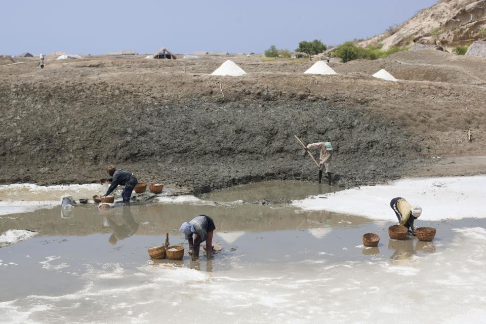 In this Wednesday, March 26, 2014 photo, workers collect salt from the salt evaporation ponds in Anse-Rouge, northwestern Haiti. Drought is hitting this region, one of the hungriest, most desolate parts of the most impoverished nation in the hemisphere and it has alarmed international aid organizations. (AP Photo/Dieu Nalio Chery)