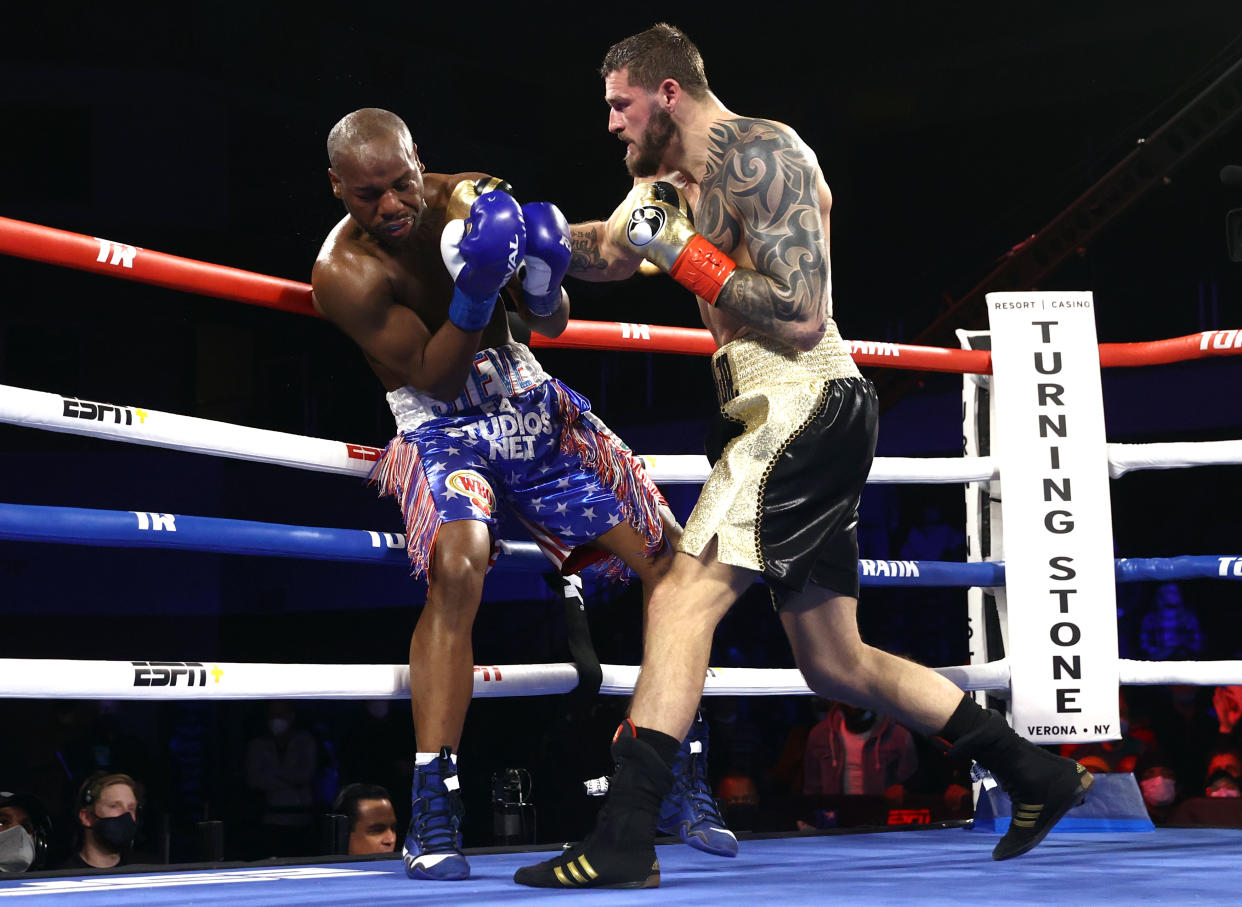 VERONA, NEW YORK - JANUARY 15: Steve Geffrard (L) and Joe Smith Jr (R) exchange punches during their fight for the WBO light heavyweight championship at Turning Stone Resort Casino on January 15, 2022 in Verona, New York. (Photo by Mikey Williams/Top Rank Inc via Getty Images)