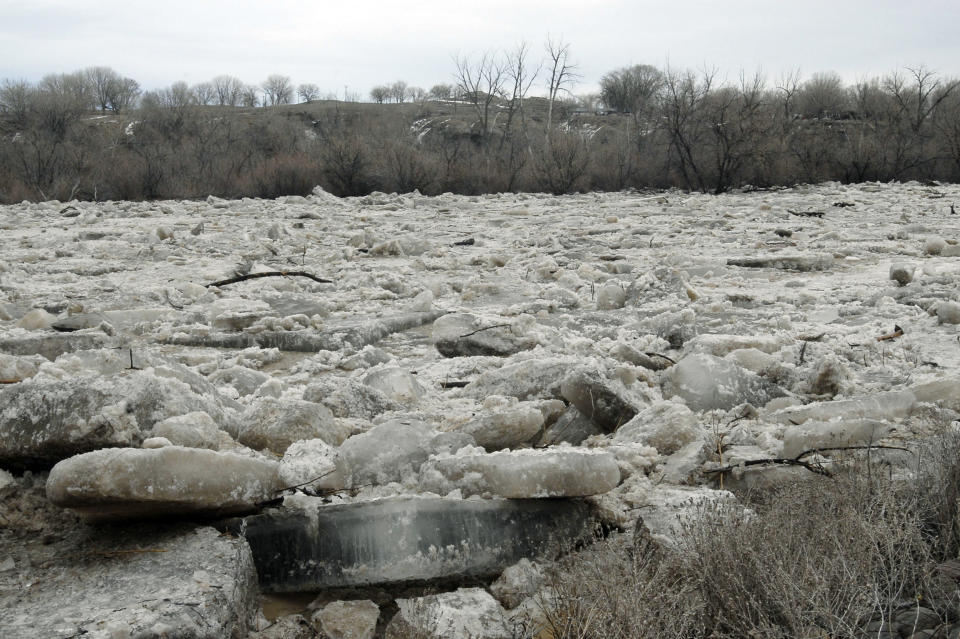 CORRECTS YEAR TO 2014 This March 9, 2014 photo provided by the Wyoming National Guard shows chunks of ice buildup in thr Horn River where community first responders and Wyoming National Guard units assisted in flood relief efforts in Graybull, Wyo. (AP Photo/Wyoming National Guard)