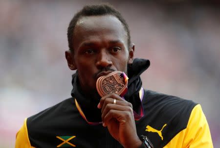 Athletics - World Athletics Championships – men’s 100 metres victory ceremony – London Stadium, London, Britain – August 6, 2017 – Usain Bolt of Jamaica (Bronze) poses with the medal. REUTERS/Matthew Childs TPX IMAGES OF THE DAY