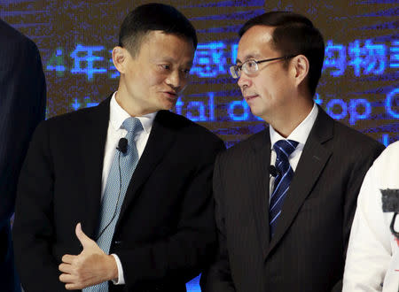 Alibaba Founder and Chairman Jack Ma (L) talks to CEO Daniel Zhang at NYSE Bell Ringing ceremony during Alibaba Group's 11.11 Global shopping festival in Beijing, China, November 11, 2015. REUTERS/Kim Kyung-Hoon/Files