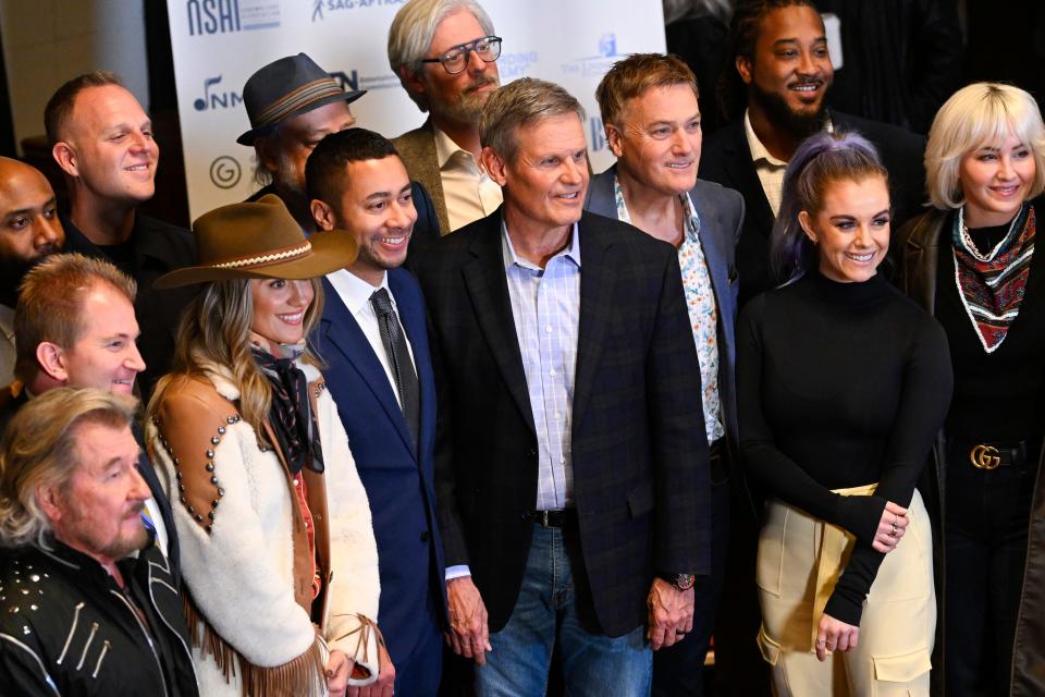 Tennessee Gov. Bill Lee, center, poses with legislative leadership, artists, songwriters and others during a news conference at RCA Records announcing new legislation designed to protect songwriters, performers and other music industry professionals against the potential dangers of artificial intelligence in Nashville, Tenn., on Jan. 10, 2024.