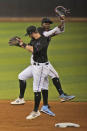 Miami Marlins' Jon Berti, foreground, and Jazz Chisholm Jr. celebrate after they defeated the Atlanta Braves in a baseball game, Saturday, June 12, 2021, in Miami. (AP Photo/Wilfredo Lee)