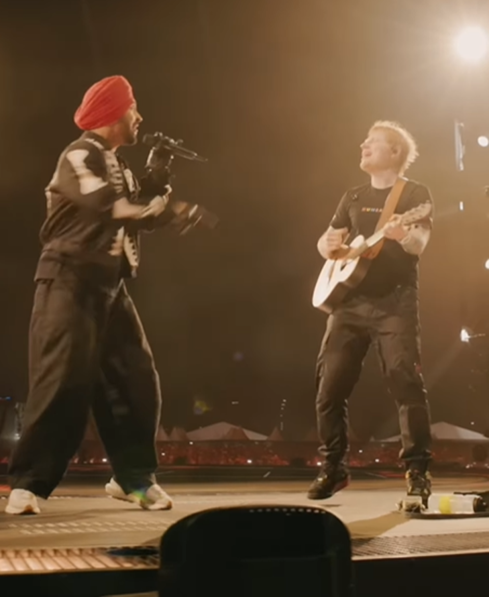 Diljit Dosanjh and Ed Sheeran pictured performing together on stage (@teddysphotos)