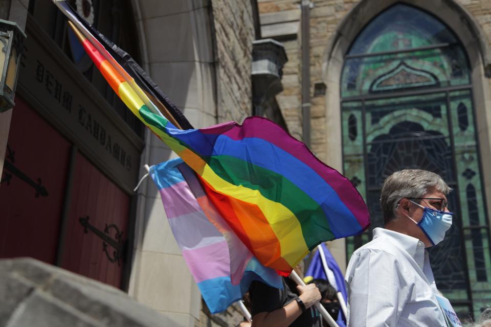 A rainbow flag flys high above Steven Goodbred, who is the father of his college-age transgender child. Goodbred is among multiple parents who joined LGBTQ advocates Friday in condemning Tennessee lawmakers for passing anti-LGBTQ bills this year.