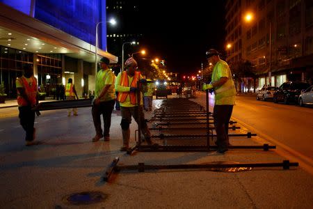 Workers erect security barricades as setup continues in advance of the Republican National Convention in Cleveland, Ohio July 15, 2016. REUTERS/Aaron P. Bernstein