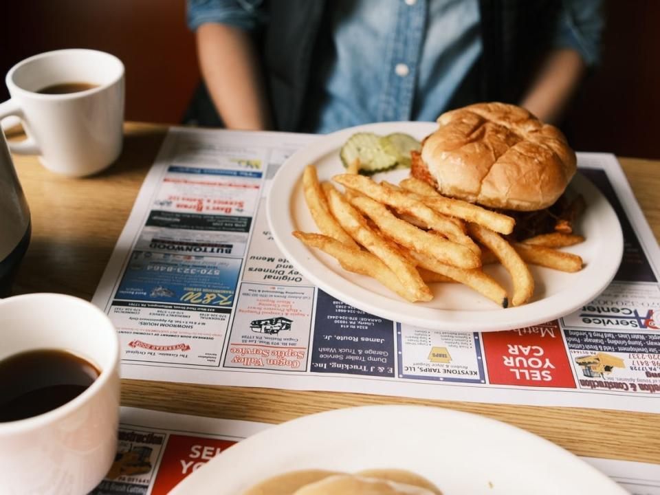 Burger and fries on plate on placemat at Fry Bros Turkey Ranch