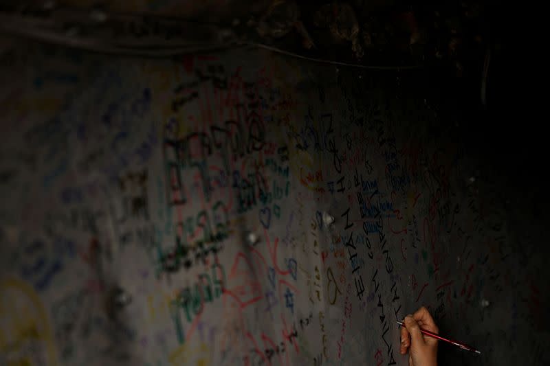 People view a tunnel set up to simulate the living conditions of kidnapped hostages, in Tel Aviv