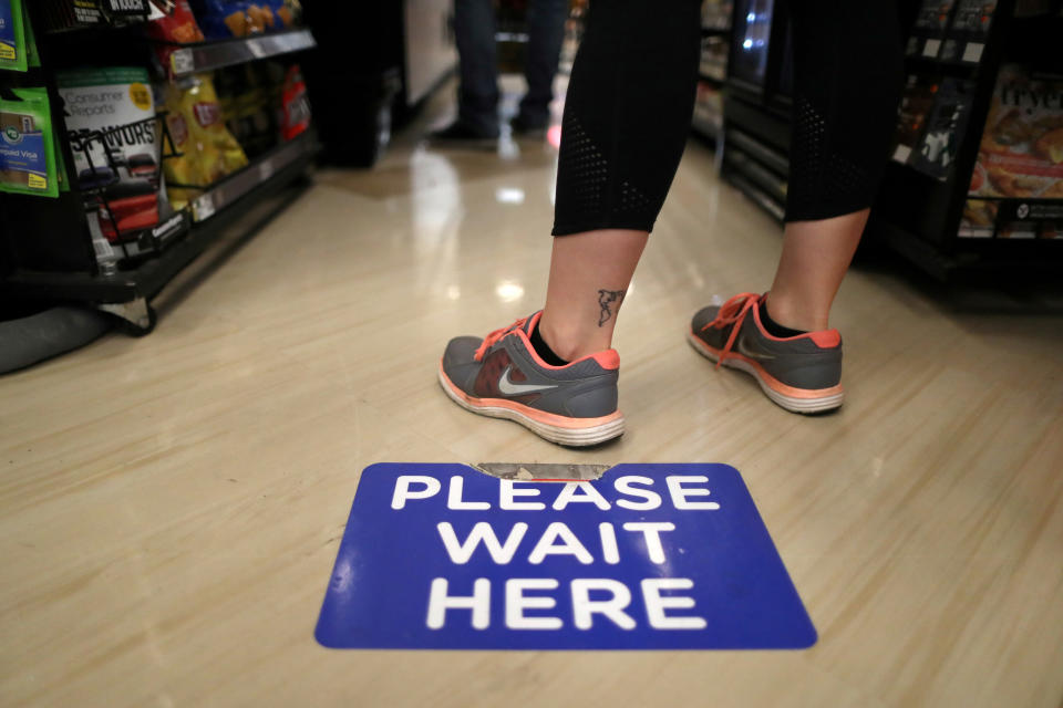 Social distancing decals are seen on the floor of a Ralphs grocery store in Los Angeles. (Photo: Lucy Nicholson / Reuters)