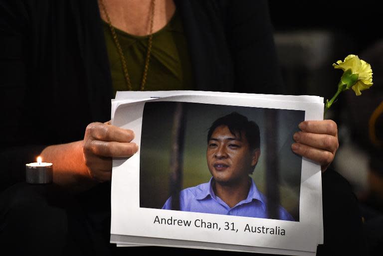 A supporter of Australians on death row in Indonesia, Andrew Chan and Myuran Sukumaran, holds a portrait of Chan, during a vigil at Martin Place in Sydney, on April 28, 2015