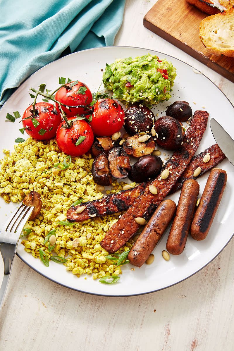 <p>We've swapped the eggs for spicy scrambled tofu, swapped the meat for our fave vegan "facon" and sausages, and even thrown in some smashed avo and griddled mushrooms and toms for even more flavour.</p><p>Get the <a href="https://www.delish.com/uk/cooking/recipes/a29572043/vegan-breakfast/" rel="nofollow noopener" target="_blank" data-ylk="slk:Vegan English Breakfast;elm:context_link;itc:0;sec:content-canvas" class="link ">Vegan English Breakfast</a> recipe.</p>