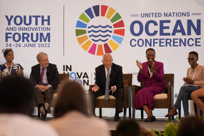 United Nations Secretary-General Antonio Guterres, 2nd left, smiles as Portuguese President Marcelo Rebelo de Sousa addresses the participants of the United Nations' Youth and Innovation Forum at Carcavelos beach, outside Lisbon, Sunday, June 26, 2022. From June 27 to July 1, the United Nations is holding its Oceans Conference in Lisbon expecting to bring fresh momentum for efforts to find an international agreement on protecting the world's oceans. (AP Photo/Armando Franca)