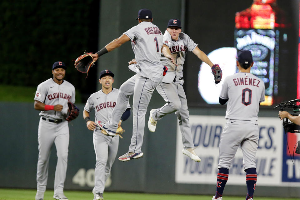 FILE - Cleveland Guardians' Amed Rosario (1) and Myles Straw jump between Oscar Gonzalez, left, Steven Kwan and Andres Gimenez (0) after the Guardians defeated the Minnesota Twins in a baseball game Wednesday, June 22, 2022, in Minneapolis. Under manager Terry Francona, baseball’s youngest team — the Guardians' average batting age (26.1) and average pitching age (26.5) are below Triple-A averages — is having fun while also developing into a playoff contender sooner than expected. (AP Photo/Andy Clayton-King)