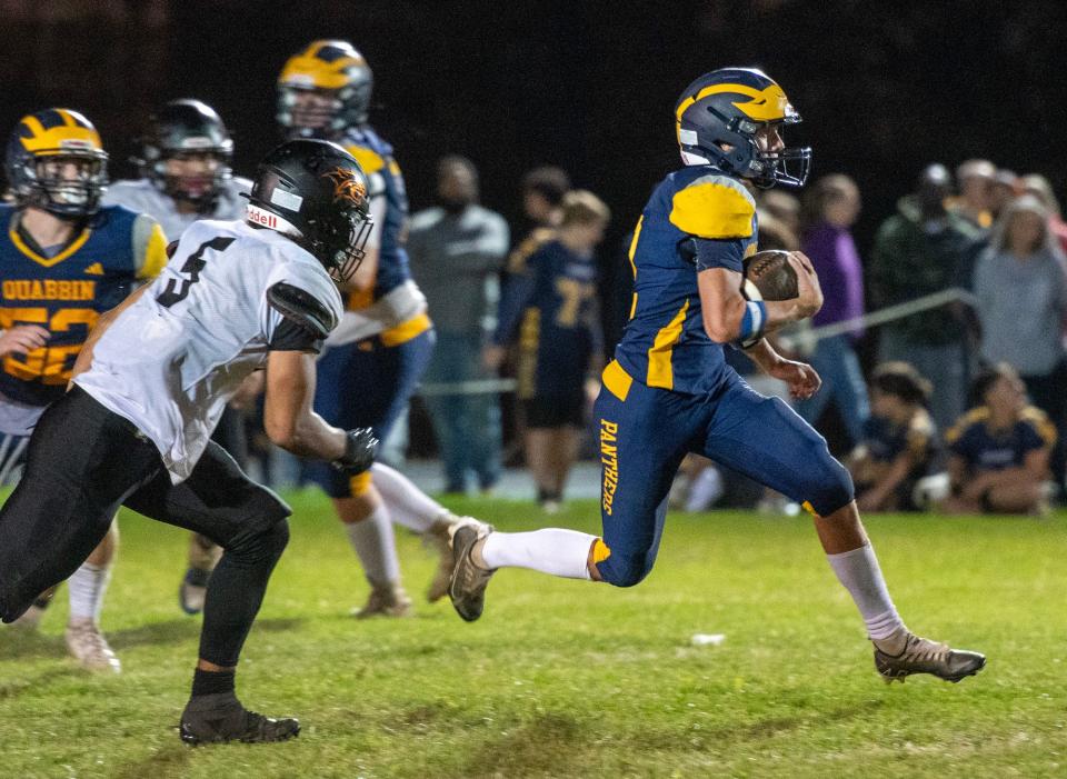 Quabbin quarterback Jaxon Warburton carries the ball in the third quarter Thursday.