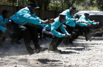 Kenyan security guards participate in physical exercise during martial arts combat training at the Chinese-run Deway Security Group compound in Kenya's capital Nairobi, March 13, 2017. REUTERS/Thomas Mukoya