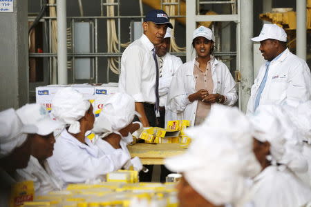 U.S. President Barack Obama (C) looks on as workers demonstrate part of the packaging process as he tours the Faffa Food factory in Addis Ababa, Ethiopia July 28, 2015. REUTERS/Jonathan Ernst