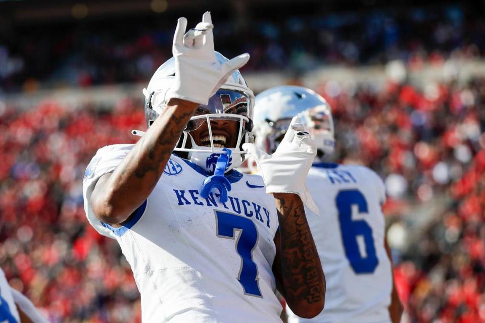 Kentucky wide receiver Barion Brown (7) celebrates a touchdown by teammate Dane Key (6) to tie the game against Louisville.