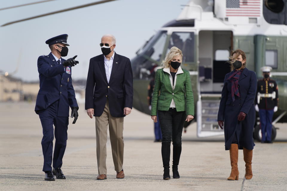 President Joe Biden and first lady Jill Biden walk to board Air Force One at Andrews Air Force Base, Md., Friday, Feb. 26, 2021. They are en route to Houston to survey damage caused by severe winter weather and encourage people to get their coronavirus shots. (AP Photo/Patrick Semansky)