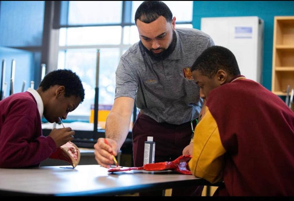 McDonogh 35 history teacher Donald Hess works with his students.