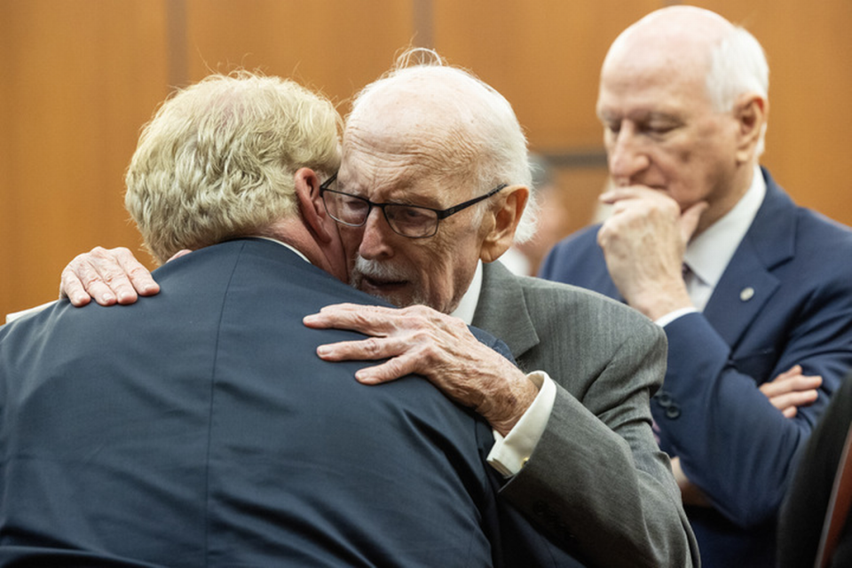 Richard Quinn Sr. hugs his son, Rick Quinn, after giving an Alford plea to four counts of perjury and two counts of obstruction of justice on Wednesday, April 19, 2023, at the Richland County Courthouse in Columbia, S.C.