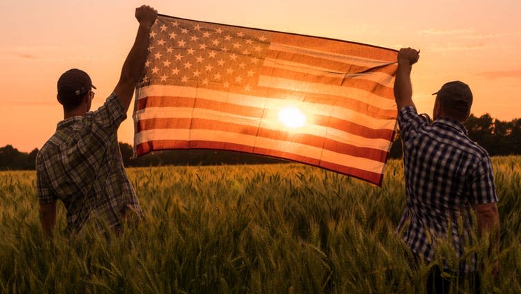 <span class="caption">In a globalised world, American farmers find their biggest market is China.</span> <span class="attribution"><a class="link " href="https://www.shutterstock.com/image-photo/two-men-energetically-raised-us-flag-1432646948" rel="nofollow noopener" target="_blank" data-ylk="slk:Shutterstock;elm:context_link;itc:0;sec:content-canvas">Shutterstock</a></span>