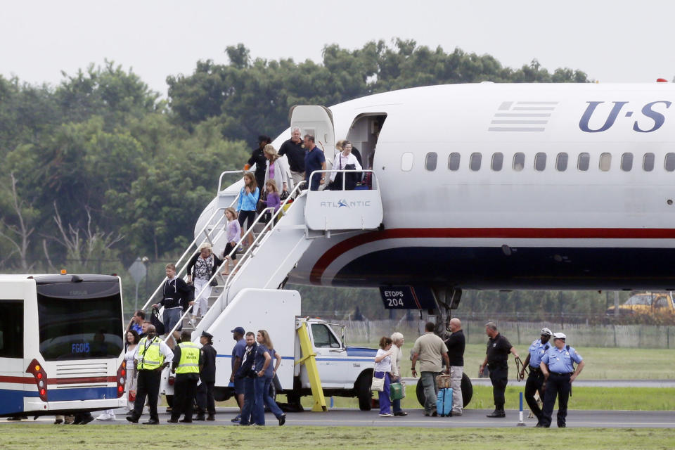 People exit a plane from Ireland that made an emergency landing because of an unspecified threat, Wednesday, Aug. 7, 2013, in Philadelphia. (AP Photo/Matt Rourke)