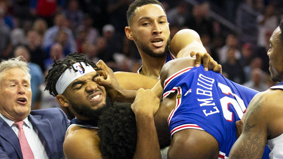 Ben Simmons, pictured trying to break up a scuffle between Joel Embiid and Karl-Anthony Towns, was not suspended for his actions.