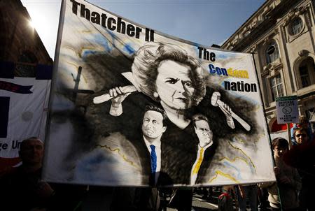 Demonstrators hold banners during a protest march on the first day of the Conservative Party annual conference in Manchester, northern England September 29, 2013. REUTERS/Phil Noble