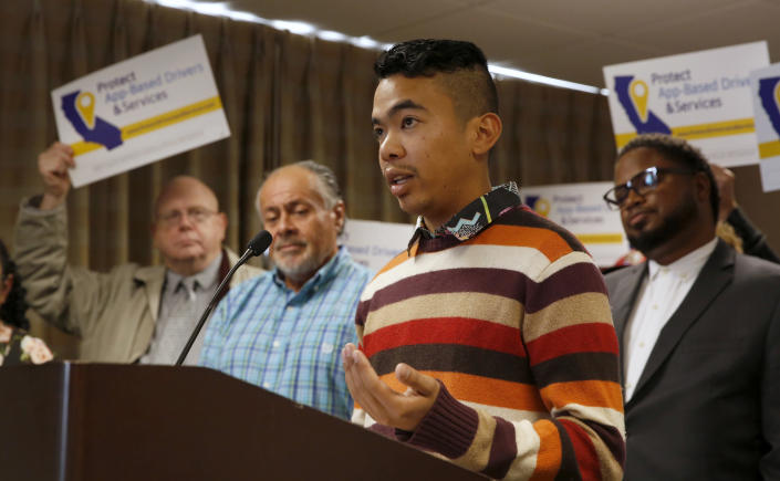 Akamine Kiarie, a college student, says working for Lyft as an independent contractor gives him the freedom to work when he wants and still be able to attend classes, during a news conference in Sacramento, Calif., Tuesday, Oct. 29, 2019. Kiarie supports a proposed ballot initiative by a group called Protect App-Based Drivers and Services that it will push a ballot initiative challenging a recently signed law that makes it harder for companies to label workers as independent contractors. If approved by voters the initiative would guarantee that drivers remain independent contractors but also receive a minimum wage and money for health insurance. (AP Photo/Rich Pedroncelli)