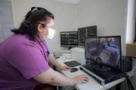 Medical staff monitor COVID-19 patients, at the Colentina Hospital in Bucharest, Romania, Thursday, Feb. 25, 2021. A year ago, Romania reported its first case of COVID-19, prompting the country's strapped medical system to turn its focus to treating COVID-19 patients. As a result, many patients with other conditions — including HIV but also cancer and other illnesses — have either been denied critical care or stopped going to their regular appointments, fearful of becoming infected.(AP Photo/Vadim Ghirda)