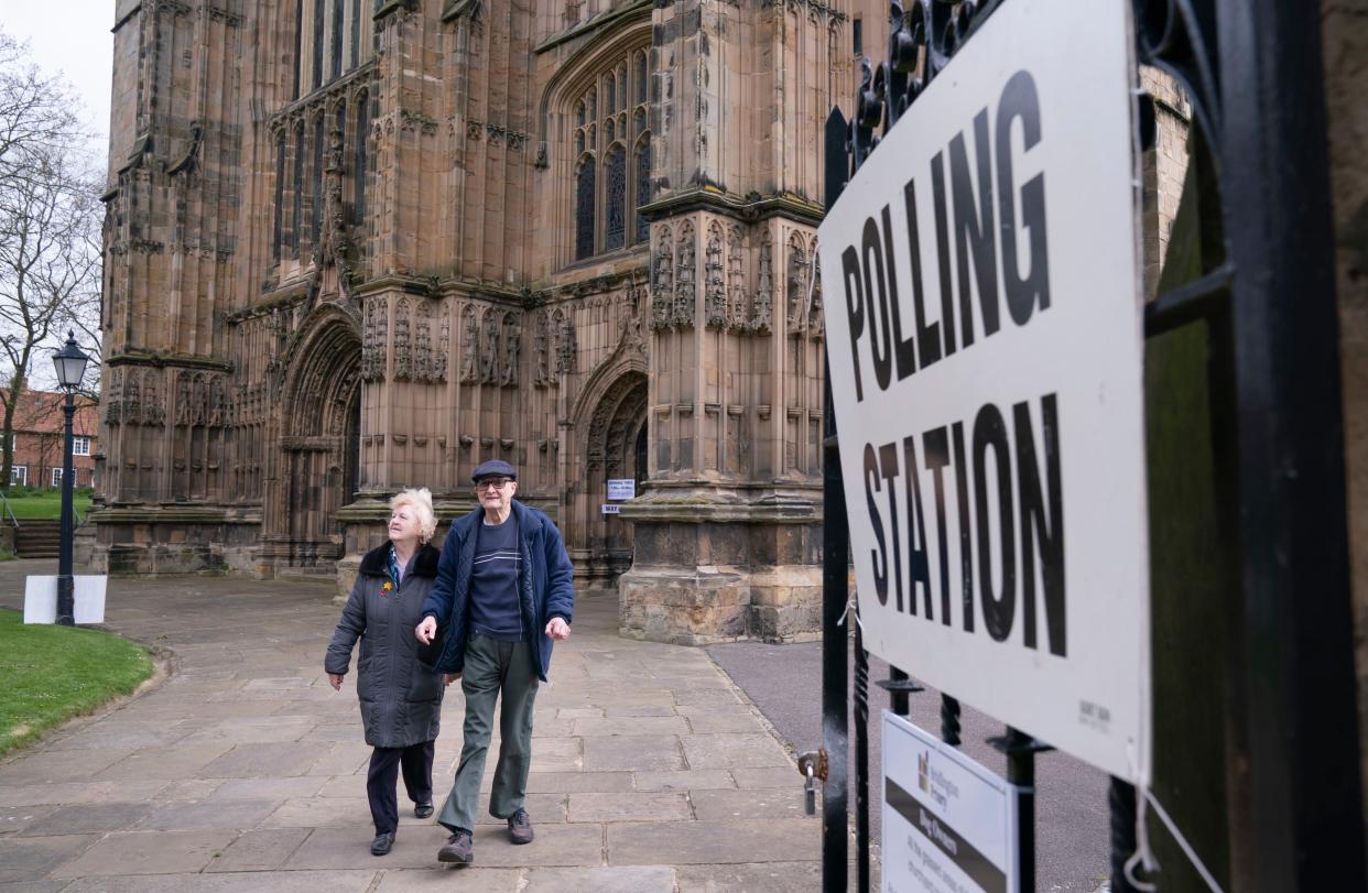 People leave after casting their vote at the polling station in Bridlington Priory Church, Yorkshire (PA)