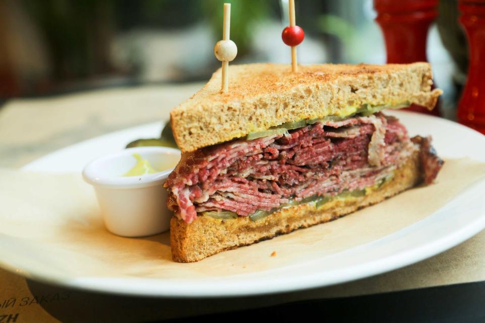 <p><strong>Pastrami on Rye</strong></p><p>If you’re a New Yorker, you know that Pastrami on Rye is the New York City staple. Stacked high enough where the sandwich doesn’t fit in your mouth years after years it remains just as in-demand. <a href="https://katzsdelicatessen.com/" rel="nofollow noopener" target="_blank" data-ylk="slk:Katz’s Delicatessen;elm:context_link;itc:0;sec:content-canvas" class="link ">Katz’s Delicatessen</a> in the East Village is the most popular location, and their sandwich does not disappoint. </p>