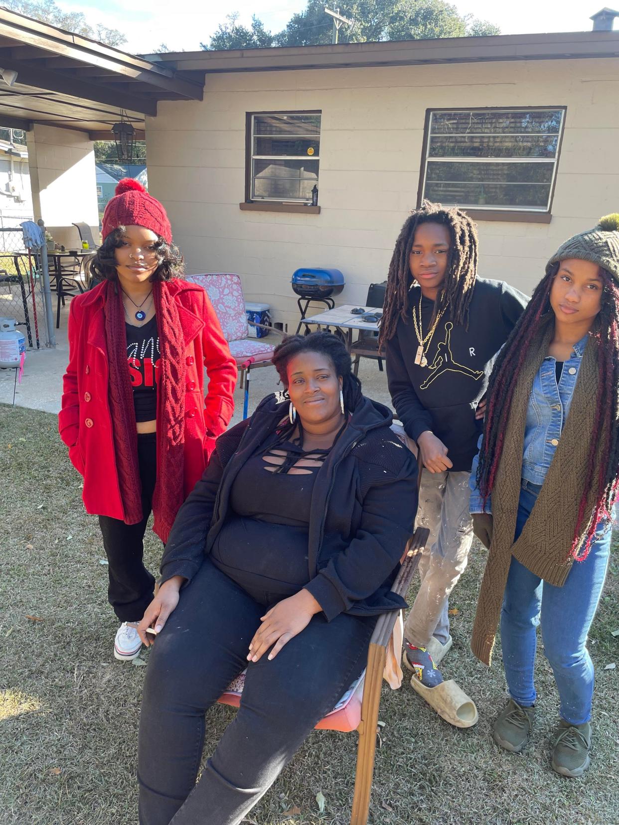 Britney Chavers, and her son and two goddaughters pose for a family portrait during the holidays. Trenity Hardy, who was shot and killed, is to the far right of the photo.