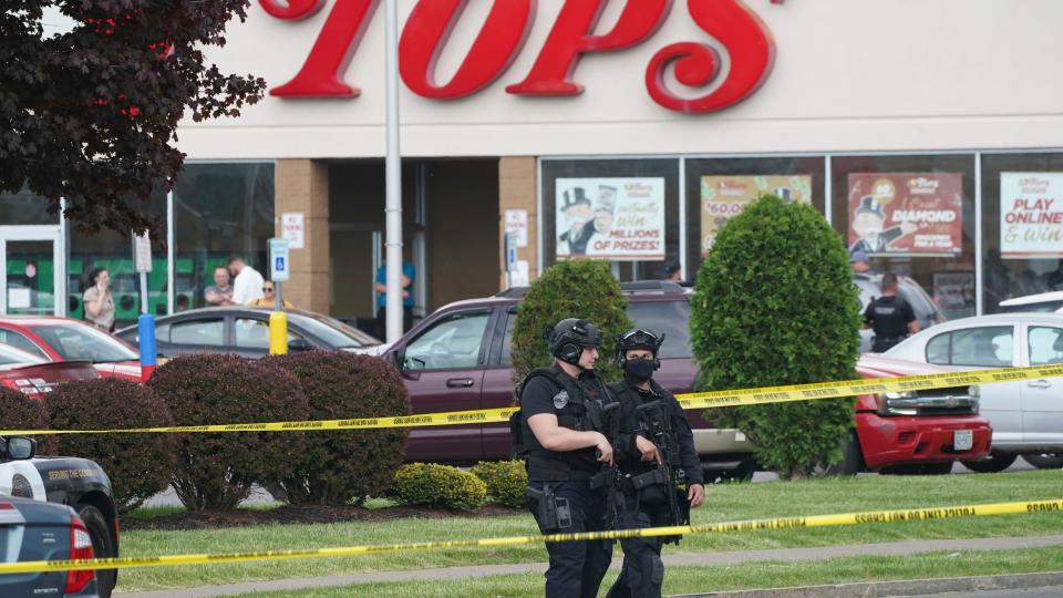 Police secure an area around a supermarket where several people were killed in a shooting, Saturday, May 14, 2022 in Buffalo, N.Y. Officials said the gunman entered the supermarket with a rifle and opened fire. Investigators believe the man may have been livestreaming the shooting and were looking into whether he had posted a manifesto online (Derek Gee/The Buffalo News via AP)