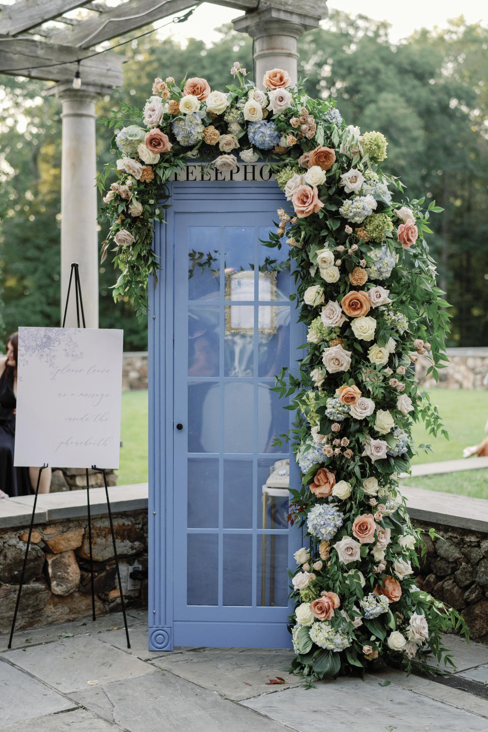 This photo shows a phone booth that contains an audio guestbook inside at the wedding of Sean Taylor and Eric Carlstrom in Richmond, Va., on Sept. 3, 2023. The bridal market is crowded with companies renting or selling vintage phones for guests to record their well wishes. (Nikki Daskalakis via AP)