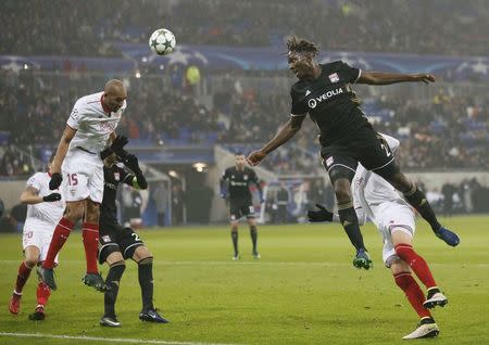 Football Soccer - Olympique Lyon v Sevilla - UEFA Champions League Group Stage - Group stage - Stade de Lyon - Decines, France - 7/12/16. Sevilla's Steven N'Zonzi in action with Olympique Lyon's Mapou Yanga Mbiwa. REUTERS/Robert Pratta