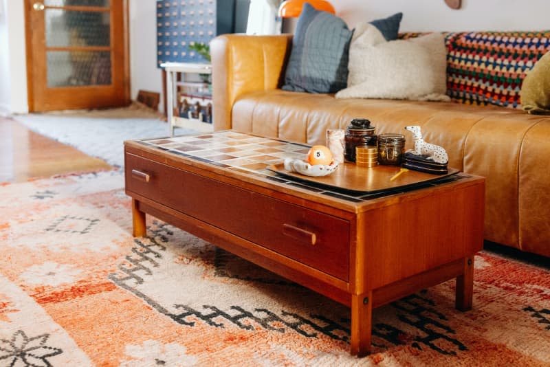 Tile tops wood coffee table in living room.