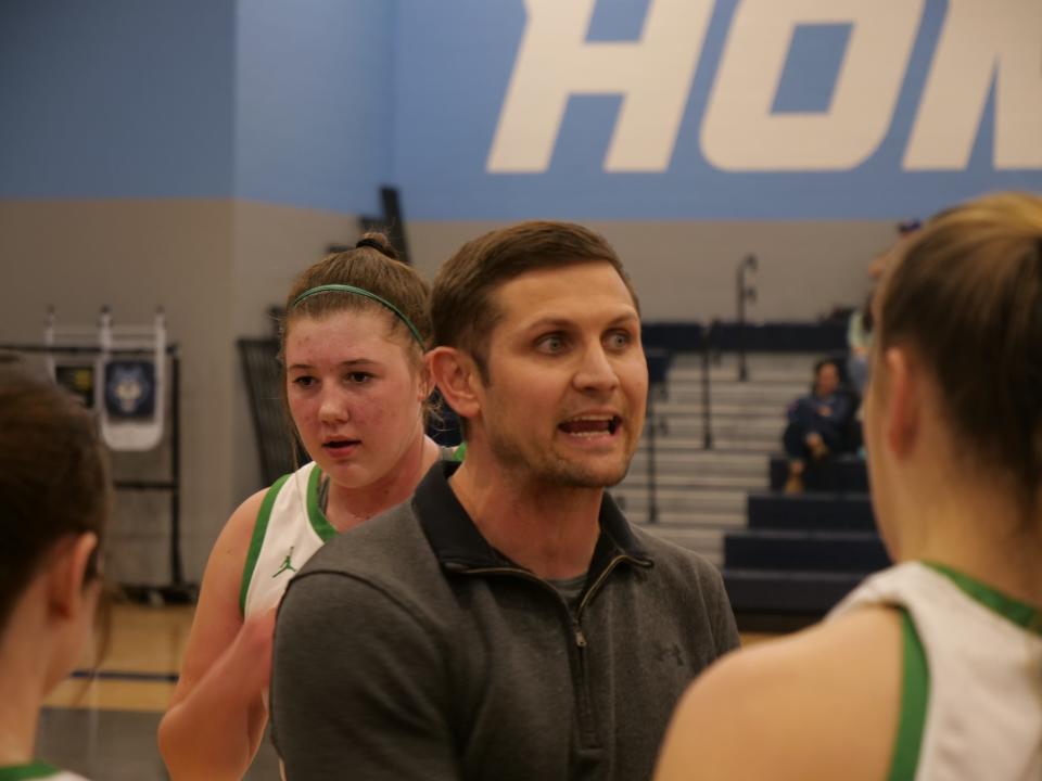 Idalou head coach Tyler Helms speaks with his team during a timeout against Dalhart in a 3A bi-district playoff game on Wednesday, February 15, 2023 at West Plains High School.