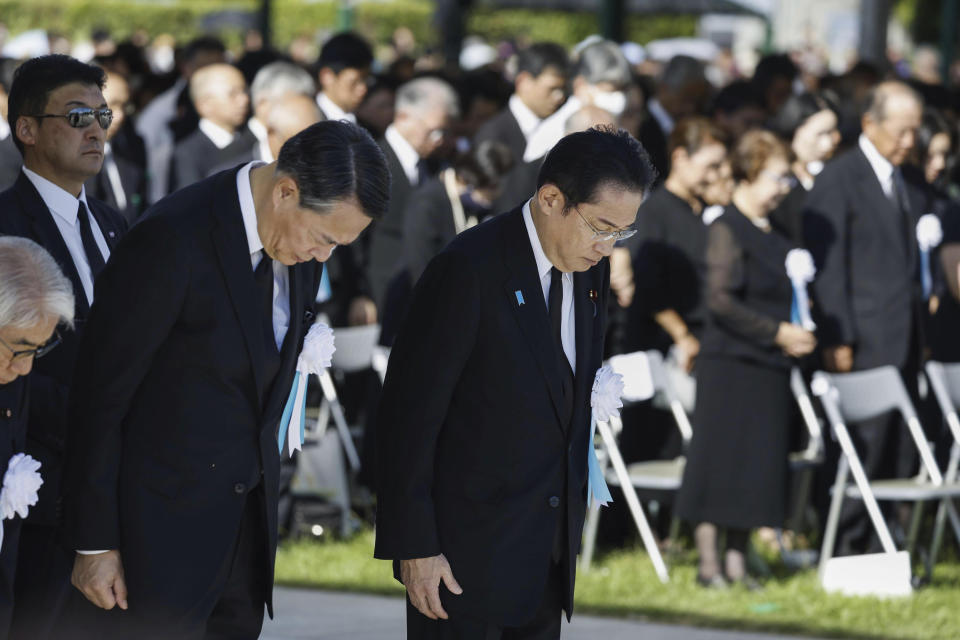 Japan's Prime Minister Fumio Kishida, front right, observes a moment of silence during a ceremony marking the 78th anniversary of the world's first atomic bombing at the Hiroshima Peace Memorial Park in Hiroshima, western Japan Sunday, Aug. 6, 2023. (Kyodo News via AP)