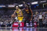 Indiana Pacers guard Kendall Brown (10) drives on Atlanta Hawks forward AJ Griffin (14) during the second half of an NBA basketball game in Indianapolis, Sunday, April 14, 2024. (AP Photo/Michael Conroy)