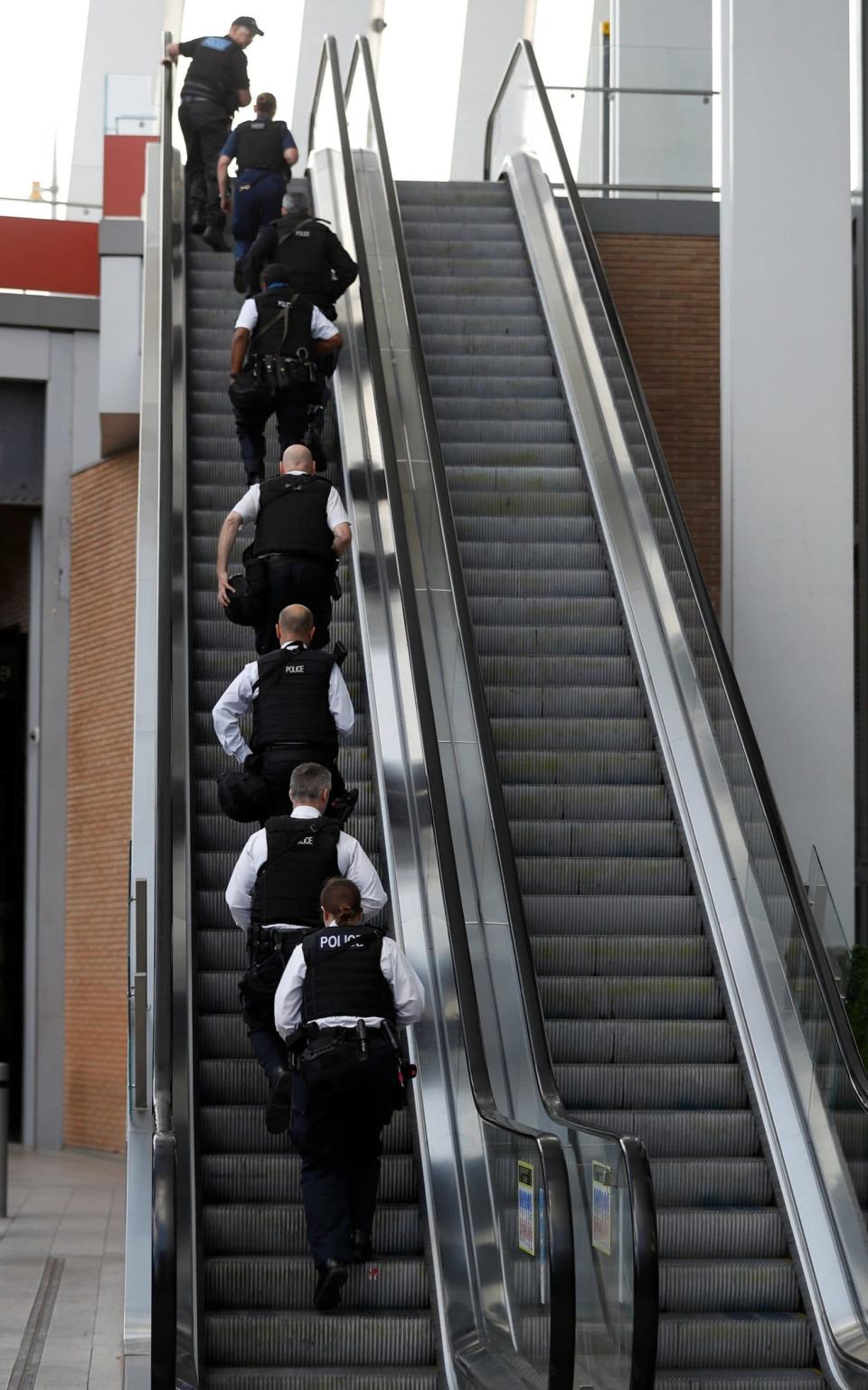 Armed police officers climb an escalator near London Bridge station - Credit: REUTERS/Peter Nicholls