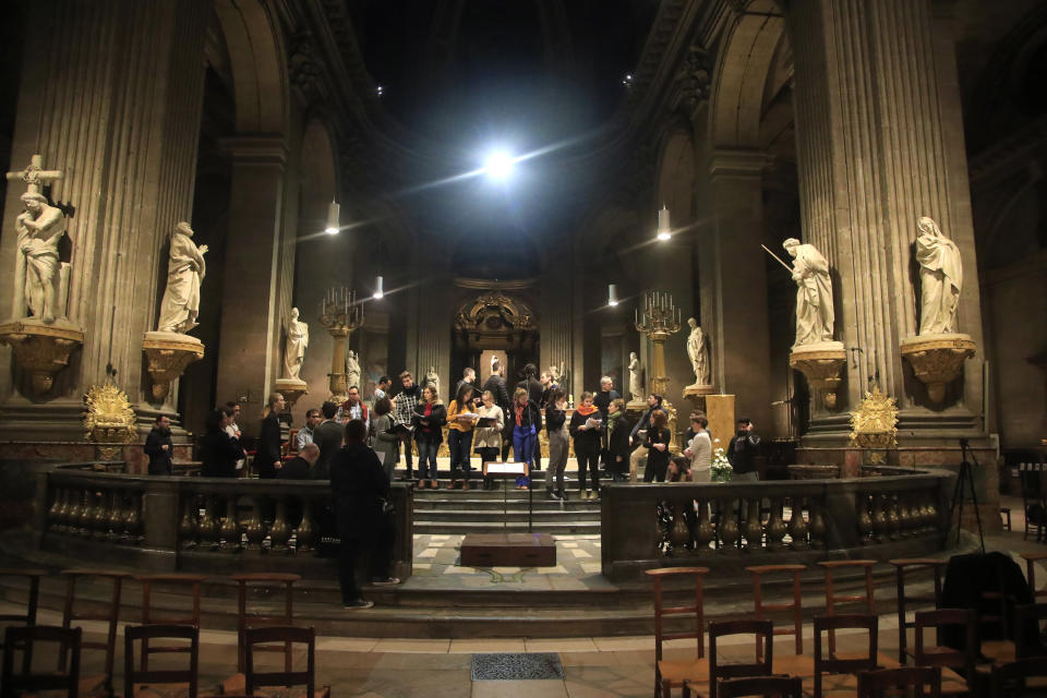 In this photo taken Monday, Dec. 16, 2019, members of the Notre Dame cathedral choir rehearse at the Saint Sulpice church in Paris. Notre Dame Cathedral kept holding services during two world wars as a beacon of hope amid bloodshed and fear. It took a fire in peacetime to finally stop Notre Dame from celebrating Christmas Mass for the first time in more than two centuries. (AP Photo/Michel Euler)