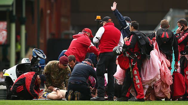 Medical personnel tend to the injured parachutist. Image: Getty